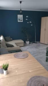 a living room with a table and a couch at Apartament Leśny in Lubin
