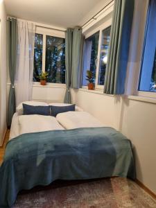 two beds sitting in a room with windows at Cozy Nest in Salzburg