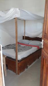 Postel nebo postele na pokoji v ubytování New Iddi Villa