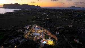an aerial view of a house with lights at Cave Bianche Hotel in Favignana