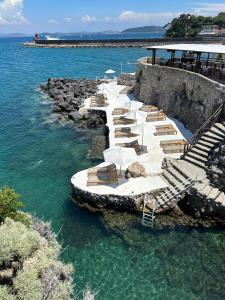 a row of lounge chairs in the water at Pagoda Lifestyle Hotel in Ischia