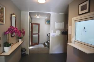 a hallway with a door leading into a room with flowers at Rjukan Gjestehus in Rjukan