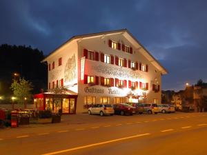 a building with cars parked in front of it at night at HOTEL&RESTAURANT Rebstock Wolhusen in Wolhusen