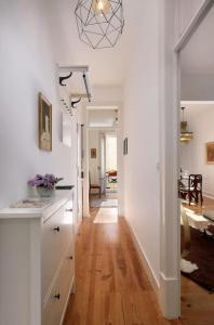 a kitchen with white walls and a wooden floor at Charming Lisbon Central Apartment in Lisbon