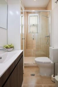 a bathroom with a shower and a toilet and a sink at Charming Lisbon Central Apartment in Lisbon