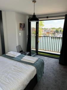 a bedroom with a bed and a large window at Duplex Apartment Harbourside city centre in Bristol +59 photos
