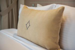 a pillow sitting on top of a bed at Jood Hotel Apartments in Dubai