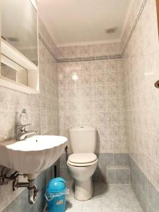 a bathroom with a white toilet and a sink at Big Apt 3bed 3bath 10 min walk Acropolis in Athens