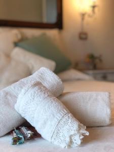 a rolled up towel on top of a bed at Jess & Joe's in Castelvetrano Selinunte