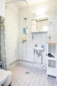 a bathroom with a shower and a sink at Tuurin Yösäilö in Tuuri