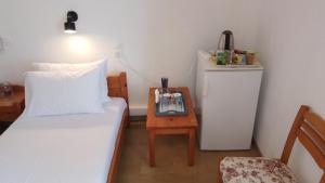 a bedroom with a bed and a table with a night stand at Loggia in Agia Galini