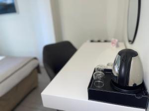 a black tea kettle sitting on top of a desk at Villa Berlioz in Nice +39 photos