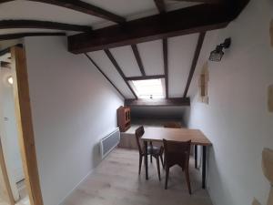 a dining room with a wooden table and chairs at AGUR MAITEA in Biarritz +5 photos