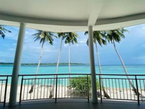 a view of the beach from the balcony of a resort at Nasara Resort Mentawai in Tua Pejat