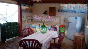 a kitchen with a table with a vase of flowers on it at Casa Sarina in San Vito lo Capo