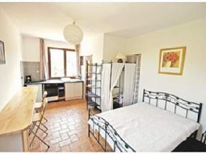 1 dormitorio con 1 cama y cocina con mesa en Studio sur Pinède, en Argelès-sur-Mer