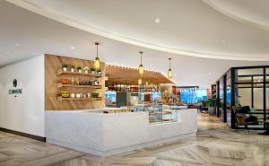 a lobby of a restaurant with a counter at Sheraton Amsterdam Airport Hotel and Conference Center in Schiphol