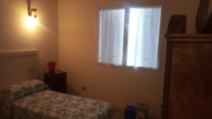 Schlafzimmer mit einem Bett und einem Fenster mit weißen Vorhängen in der Unterkunft Bed & Breakfast DA BARTAI in Musile di Piave