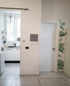 a white door in a kitchen with a sink at Petracca Guest House in Monopoli