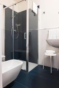 a bathroom with a shower and a tub and a sink at Hotel Sylvia in Lido di Camaiore