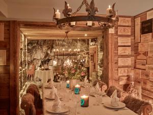 a dining room with a long table with candles at Firefly Luxury Suites in Zermatt