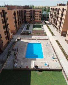 an overhead view of an apartment complex with a swimming pool at APARTAMENTO BARAJAS-IFEMA in Madrid