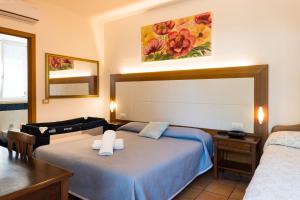 Postel nebo postele na pokoji v ubytování Hotel Sylvia