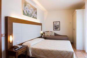 Postel nebo postele na pokoji v ubytování Hotel Sylvia