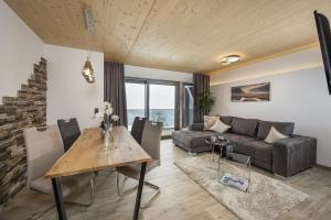 a living room with a table and a couch at Weitenmoos Panorama Apart & Rooms in Sankt Johann im Pongau