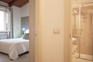 a bedroom with a bed and a glass shower at Chic apartment in the historic center of Perugia in Perugia