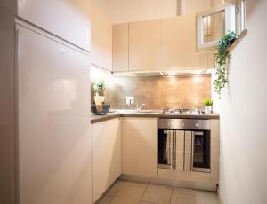 a small kitchen with a sink and a refrigerator at Chic apartment in the historic center of Perugia in Perugia