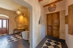 a room with a hallway with a door and a bedroom at The Riad - Adults Only in Tarifa