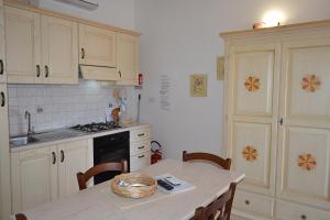 a kitchen with a table with a basket on it at Vistamare in Orosei