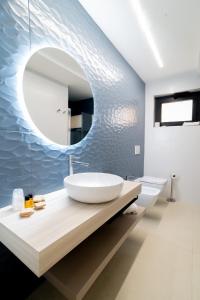 a bathroom with a sink and a mirror on a counter at Hotel La Principessa in Campora San Giovanni