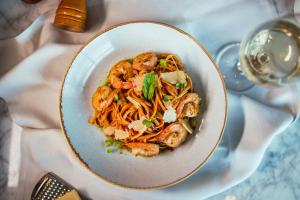 a bowl of shrimp pasta on a table at The Westin Pune Koregaon Park in Pune