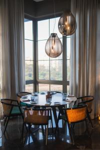 a dining room table with chairs in front of a window at The Westin Pune Koregaon Park in Pune