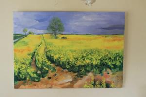 a painting of a field of flowers on a wall at Ferienwohnung _Schwalbennest_ in Glave