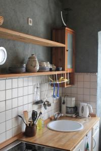 a kitchen with a sink and a counter top at Ferienwohnung _Schwalbennest_ in Glave