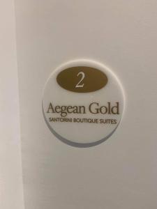 a sign on a door with aascan goldenna bathroom suite at Aegean Gold in Kamari