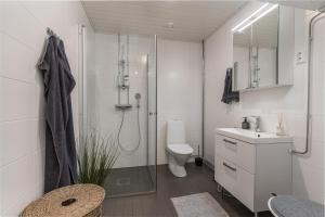 a bathroom with a shower and a toilet and a sink at DP Apartments Vaasa in Vaasa