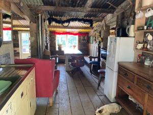 a kitchen with a dog sitting in the middle of it at Outstandingly situated cosy Shepherds Hut in Longhope