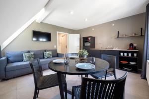 a living room with a table and chairs and a couch at La Fattoria Casa DOLCE in Unterflockenbach