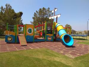 a playground with a slide in a park at Vosporos Hotel in Komotini