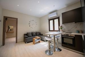a kitchen and living room with a couch and a table at River House in Kalymnos