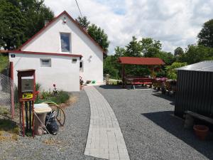 a small white house with a red roof at Maciejówka in Stará Červená Voda
