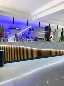 a bar in a building with purple lighting at Hotel La Principessa in Campora San Giovanni