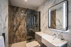 a bathroom with a sink and a mirror at Comfy Lake District Cabins - Winster, Bowness-on-Windermere in Winster