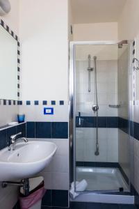 a bathroom with a sink and a shower at Hotel Sylvia in Lido di Camaiore +71 photos