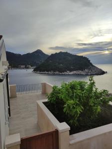 a balcony of a house with a view of the ocean at Apartmani Lešić Zaklopatica in Lastovo