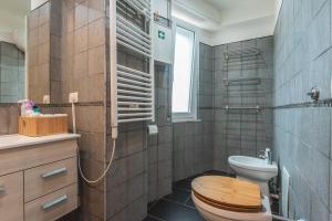 a bathroom with a toilet and a sink at Accasatua Neapolitan Apartments in Naples +42 photos